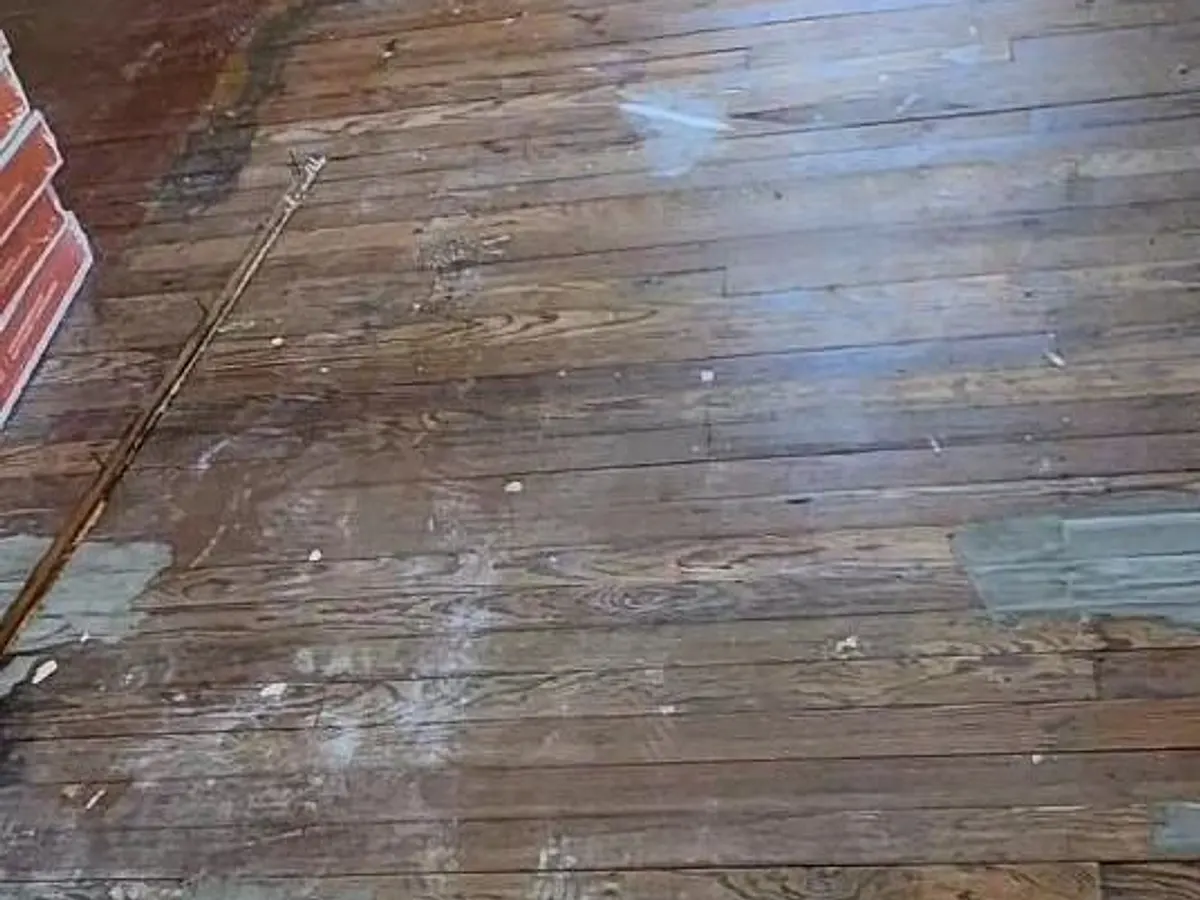 Worn, stained and patched hardwood floor