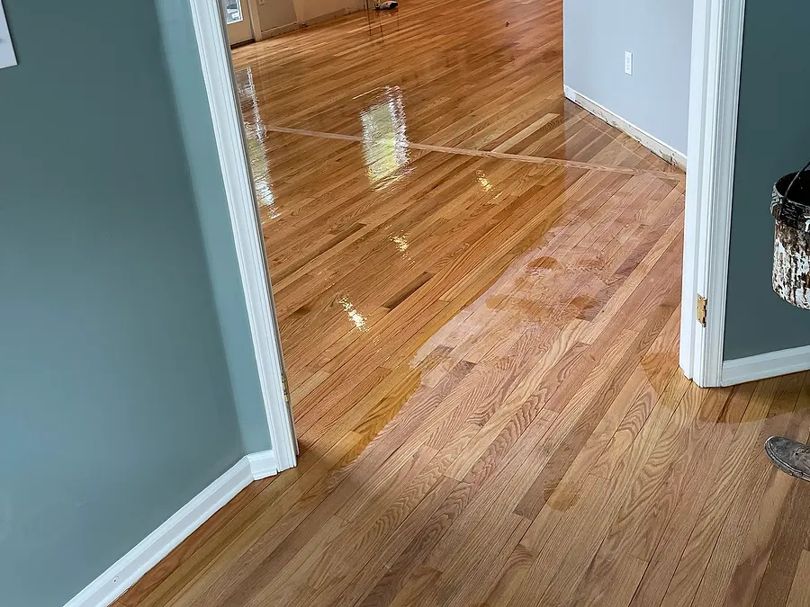 Hallway hardwood floor refinished with a glossy finish