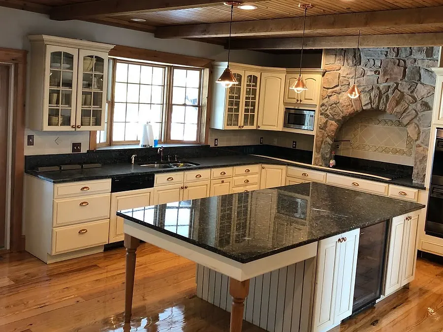 Kitchen with a freshly refinished hardwood floor and a stone hearth