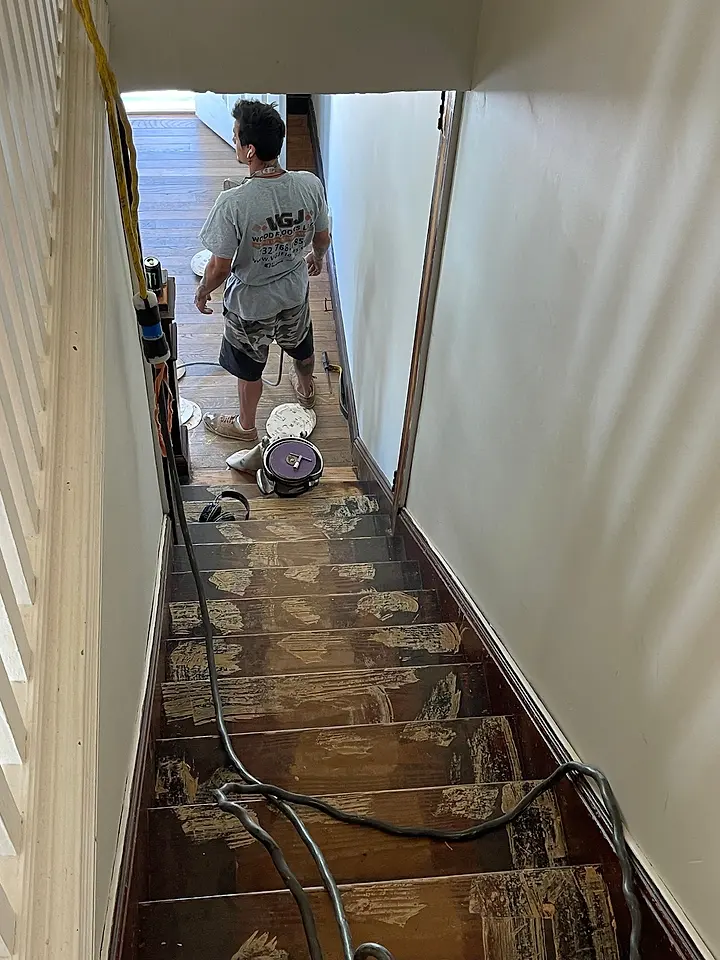 Hardwood staircase in the middle of sanding